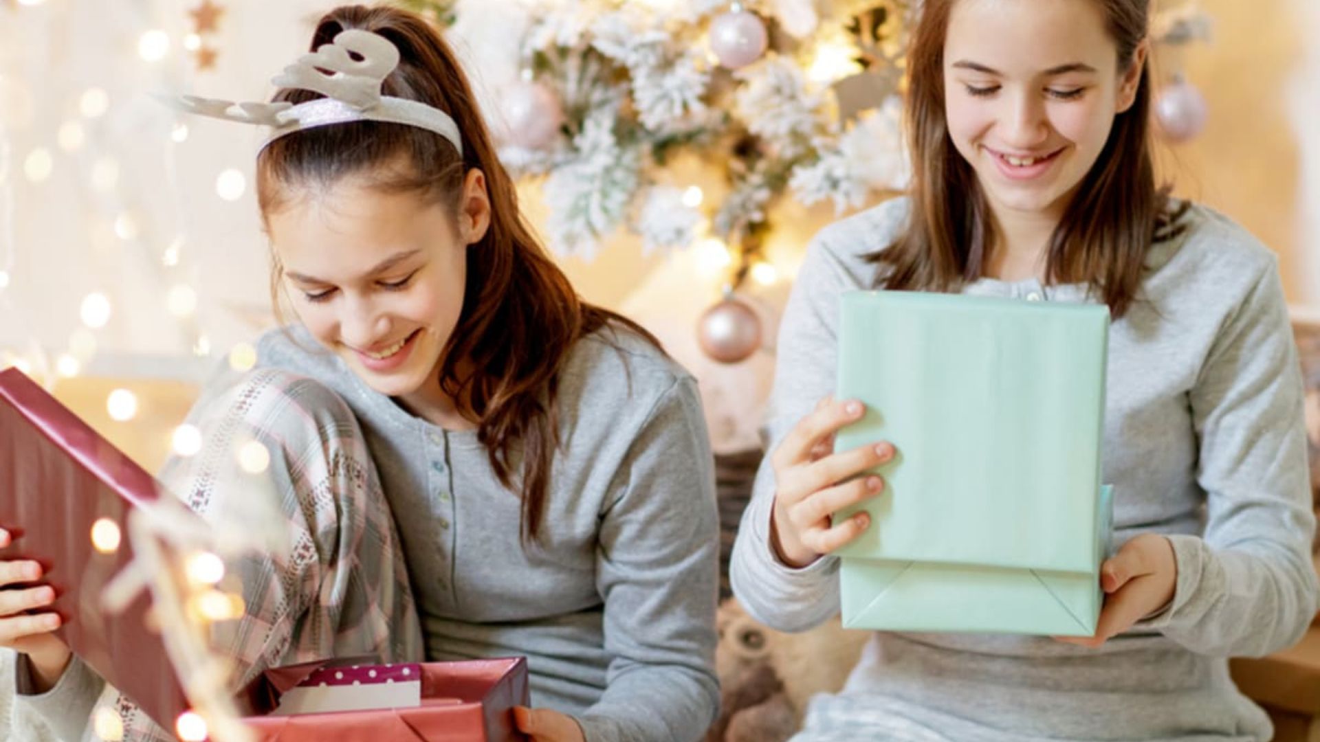 Two teenagers opening their Christmas gifts for teens 